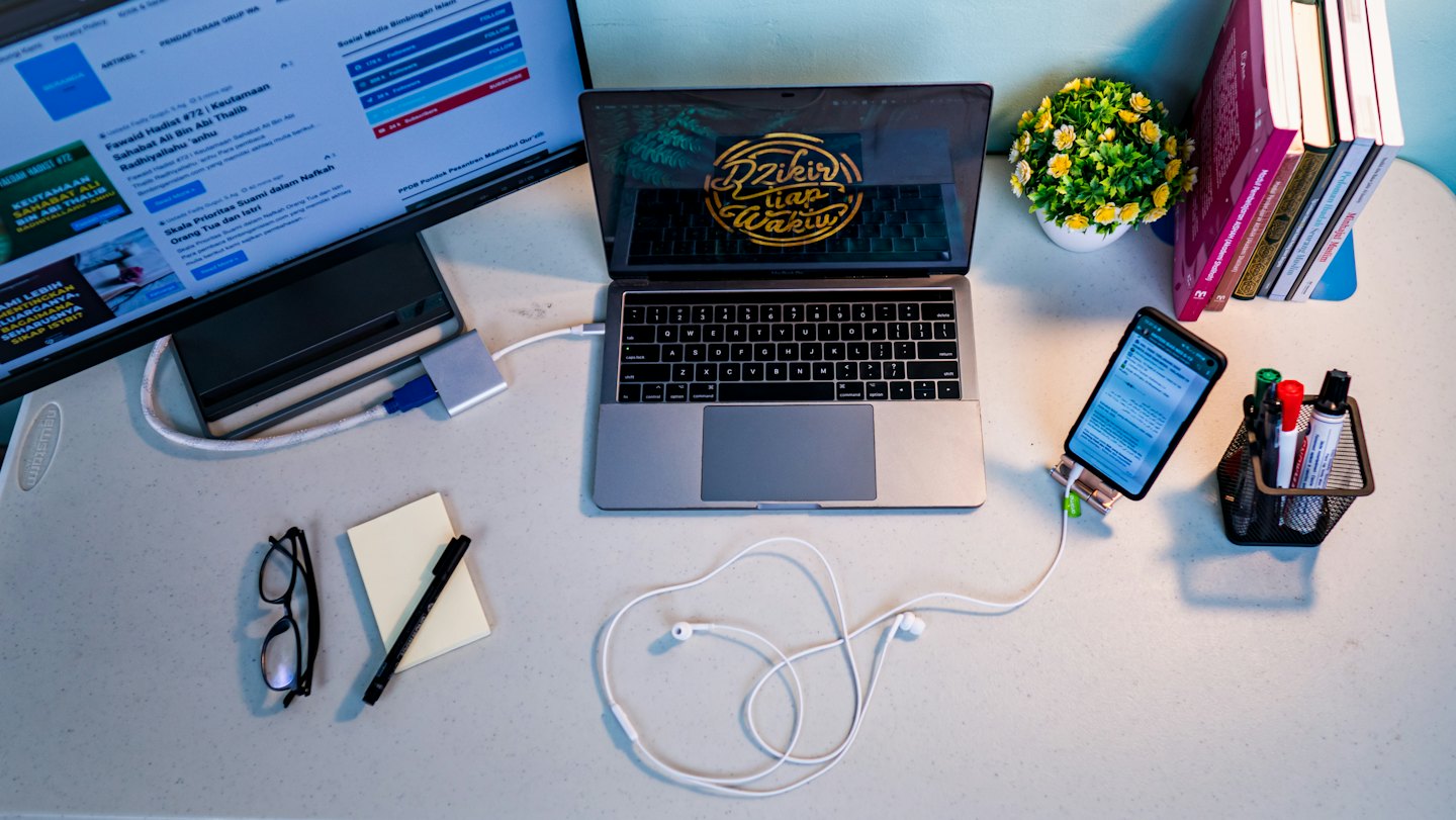 Laptop monitor and office supplies organized on a modern desk.